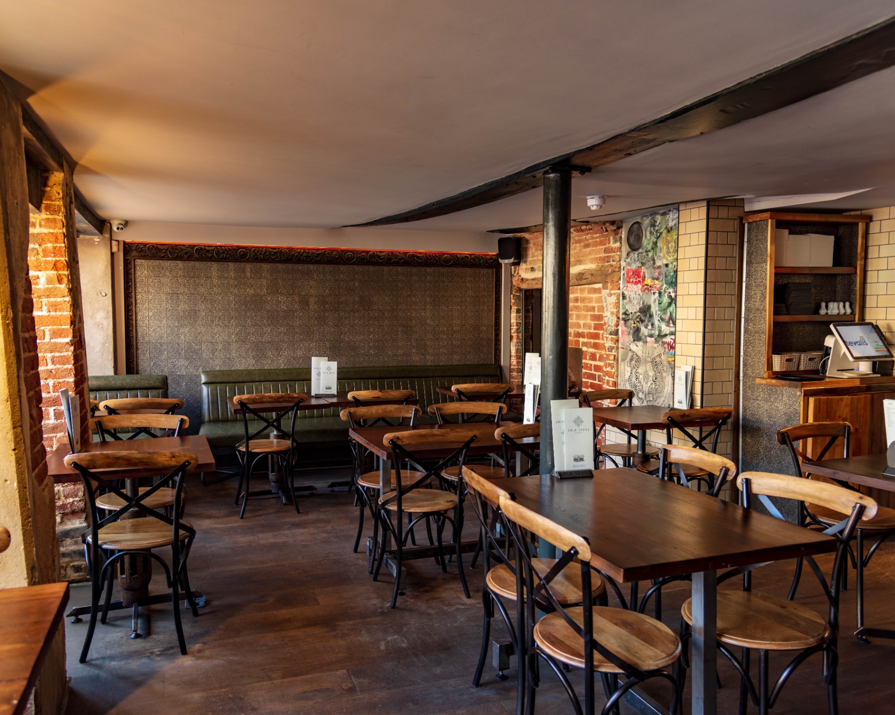 The main dining room with exposed brick and timber beams